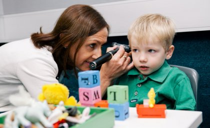 A clinician works with a child at the UQ Audiology clinic.